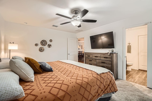 carpeted bedroom with ceiling fan and connected bathroom