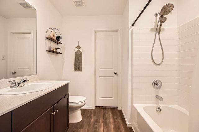 full bathroom with vanity, shower / bathing tub combination, hardwood / wood-style floors, and toilet