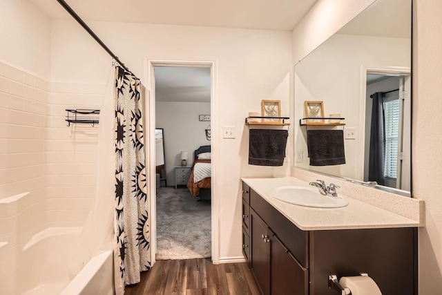 bathroom with vanity, hardwood / wood-style floors, and shower / tub combo