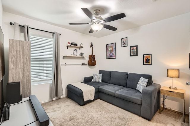 carpeted living room featuring ceiling fan and a healthy amount of sunlight