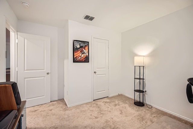 unfurnished bedroom featuring light carpet