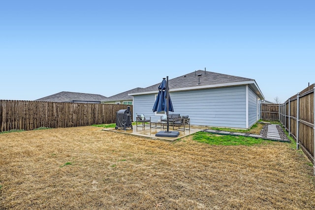 back of property featuring a yard and a patio area