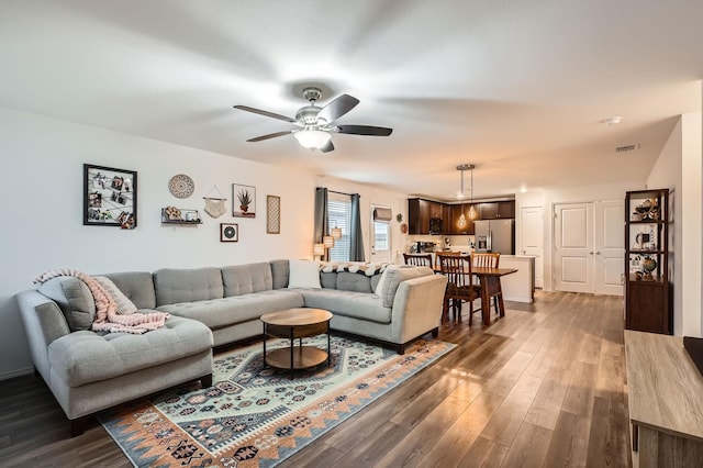 living room featuring dark hardwood / wood-style floors and ceiling fan