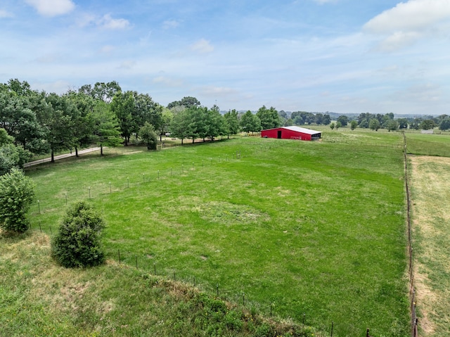 view of yard featuring an outbuilding and a rural view