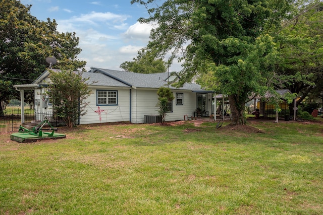 back of house featuring cooling unit and a yard