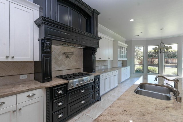 3019 Haywick, The Colony, TX 75056 - kitchen with a sink, stainless steel gas cooktop, ornamental molding, and white cabinets