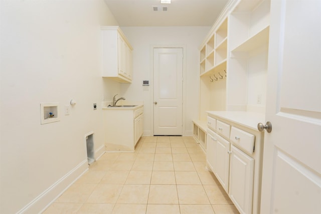 3019 Haywick, The Colony, TX 75056 - laundry area featuring cabinet space, light tile patterned floors, hookup for a washing machine, gas dryer hookup, and baseboards
