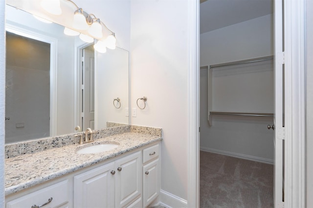 3019 Haywick, The Colony, TX 75056 - bathroom with a spacious closet, vanity, and baseboards