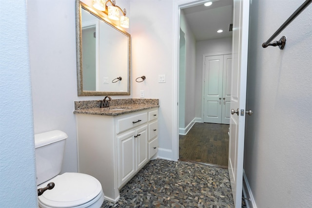 3019 Haywick, The Colony, TX 75056 - bathroom with toilet, vanity, recessed lighting, and baseboards