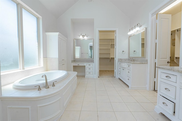 3019 Haywick, The Colony, TX 75056 - full bathroom with tile patterned flooring, a bath, vaulted ceiling, vanity, and a spacious closet