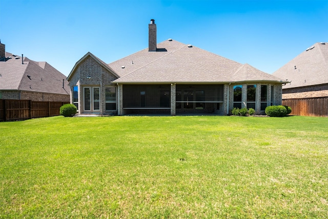 3019 Haywick, The Colony, TX 75056 - rear view of house with brick siding, a chimney, a sunroom, and a shingled roof