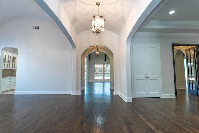 3019 Haywick, The Colony, TX 75056 - foyer with arched walkways, dark wood-type flooring, a chandelier, and baseboards