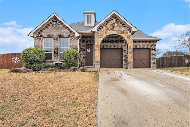 front of property featuring a garage and a front lawn