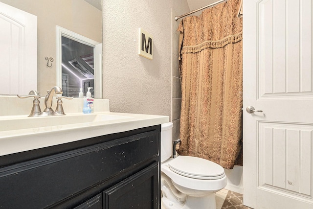 bathroom featuring vanity, curtained shower, and toilet