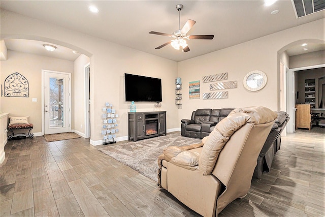 living room with ceiling fan and light wood-type flooring