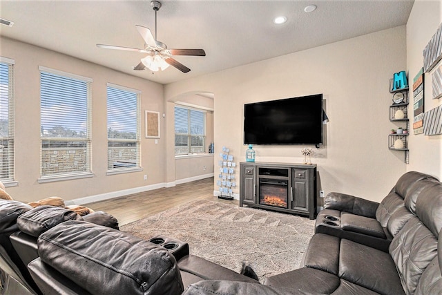 living room with plenty of natural light, hardwood / wood-style floors, and ceiling fan