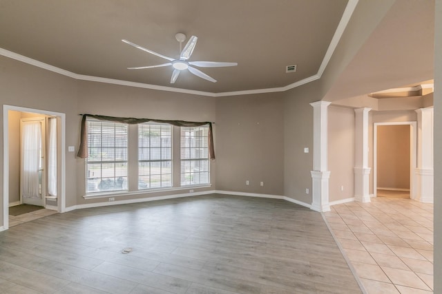 spare room featuring ornamental molding, light wood-type flooring, decorative columns, and ceiling fan