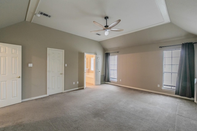 unfurnished bedroom featuring lofted ceiling, connected bathroom, light carpet, visible vents, and baseboards