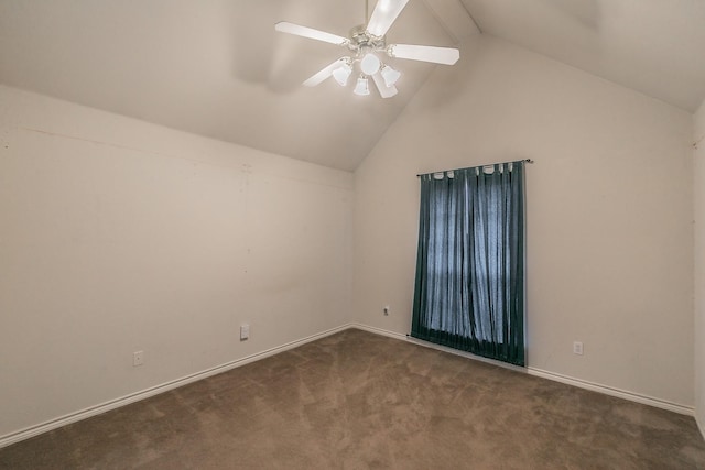 spare room featuring lofted ceiling, dark colored carpet, a ceiling fan, and baseboards