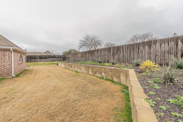 view of yard with a fenced backyard