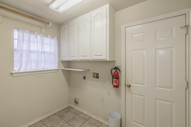 laundry room featuring light tile patterned floors, washer hookup, baseboards, cabinet space, and electric dryer hookup