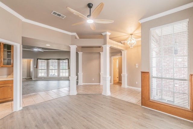 empty room featuring ceiling fan, light tile patterned floors, visible vents, ornamental molding, and ornate columns