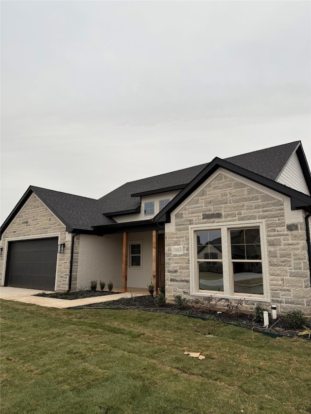 view of front of house with a garage and a front yard