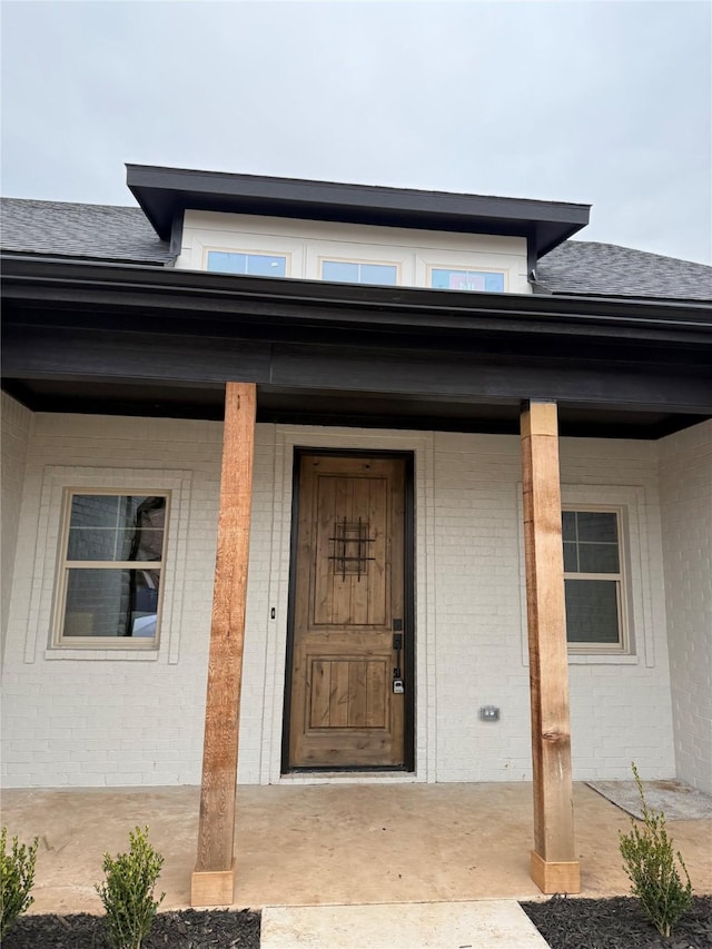 property entrance with covered porch