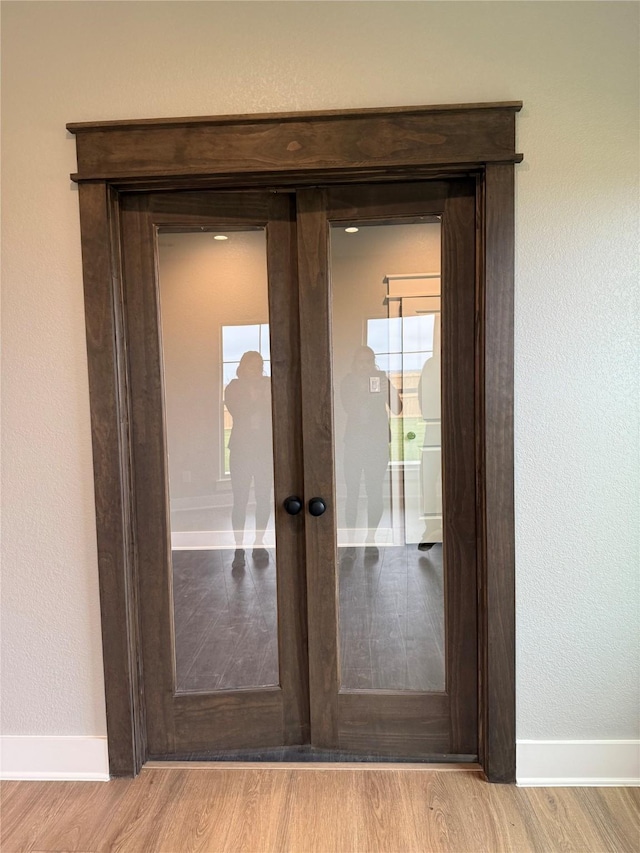 doorway featuring light wood-type flooring and french doors