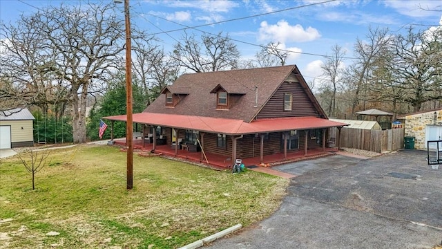 view of front of property with covered porch and a front lawn