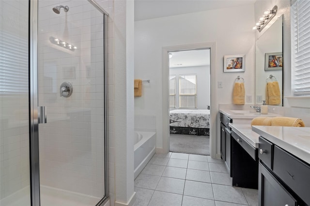 ensuite bathroom with vanity, tile patterned floors, a shower stall, and ensuite bath