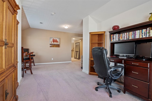 office area with vaulted ceiling and light carpet