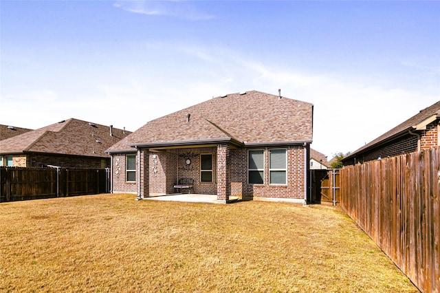 back of house featuring a yard and a patio