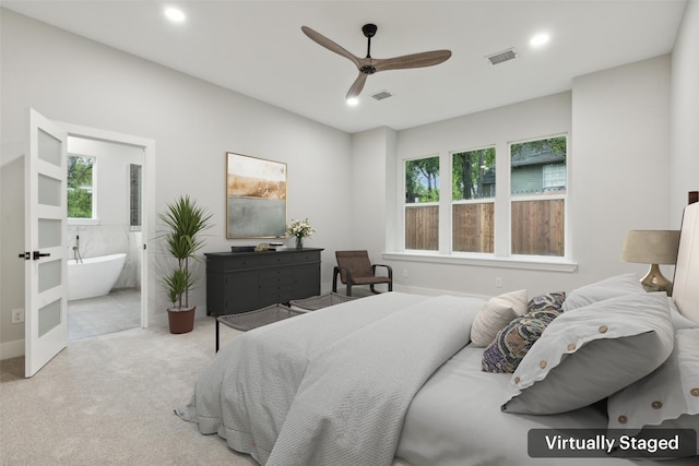 bedroom with light carpet, connected bathroom, and ceiling fan