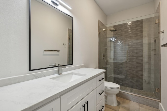 bathroom with vanity, toilet, and a shower with shower door