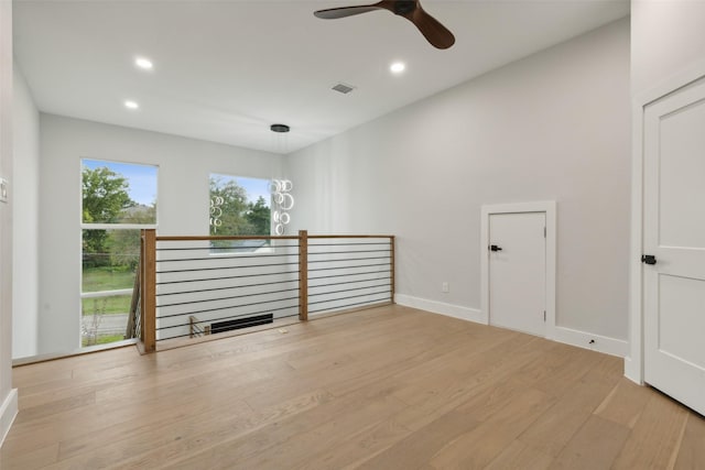 unfurnished living room featuring ceiling fan and light wood-type flooring