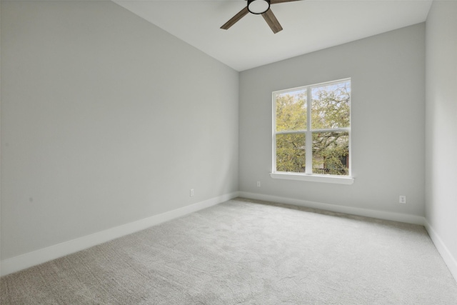 spare room with ceiling fan and carpet