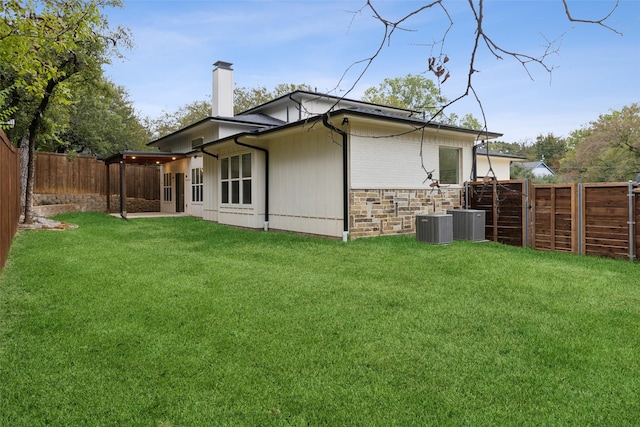 view of side of property featuring a yard and central air condition unit