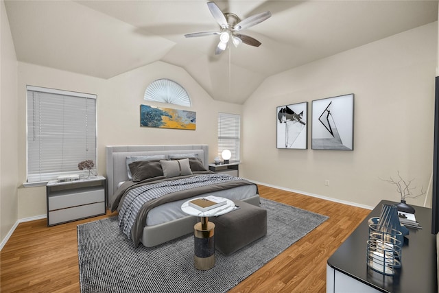 bedroom featuring hardwood / wood-style floors, vaulted ceiling, and ceiling fan