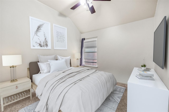 bedroom with vaulted ceiling, carpet flooring, and ceiling fan