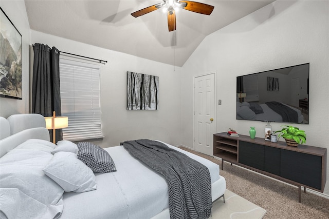 bedroom with ceiling fan, carpet flooring, and vaulted ceiling