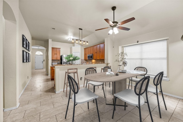 dining room with lofted ceiling and ceiling fan