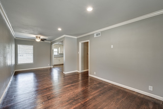 empty room with ceiling fan, crown molding, and dark hardwood / wood-style flooring