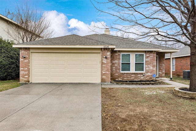 ranch-style house featuring brick siding, driveway, a garage, and a chimney