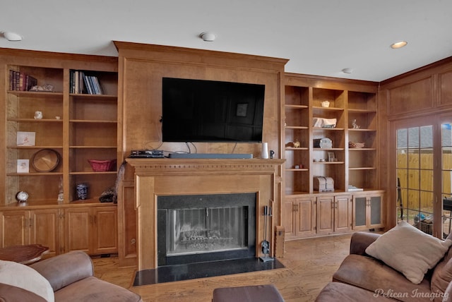 living room featuring light hardwood / wood-style floors and built in shelves