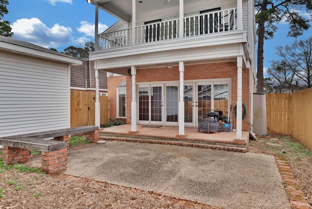 rear view of house with a patio area and a balcony