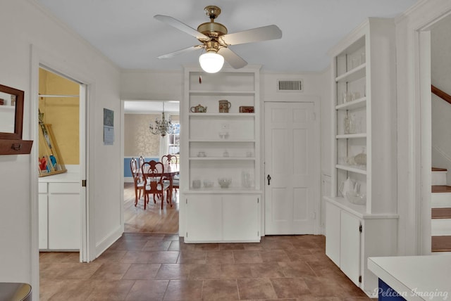 interior space featuring crown molding and ceiling fan with notable chandelier