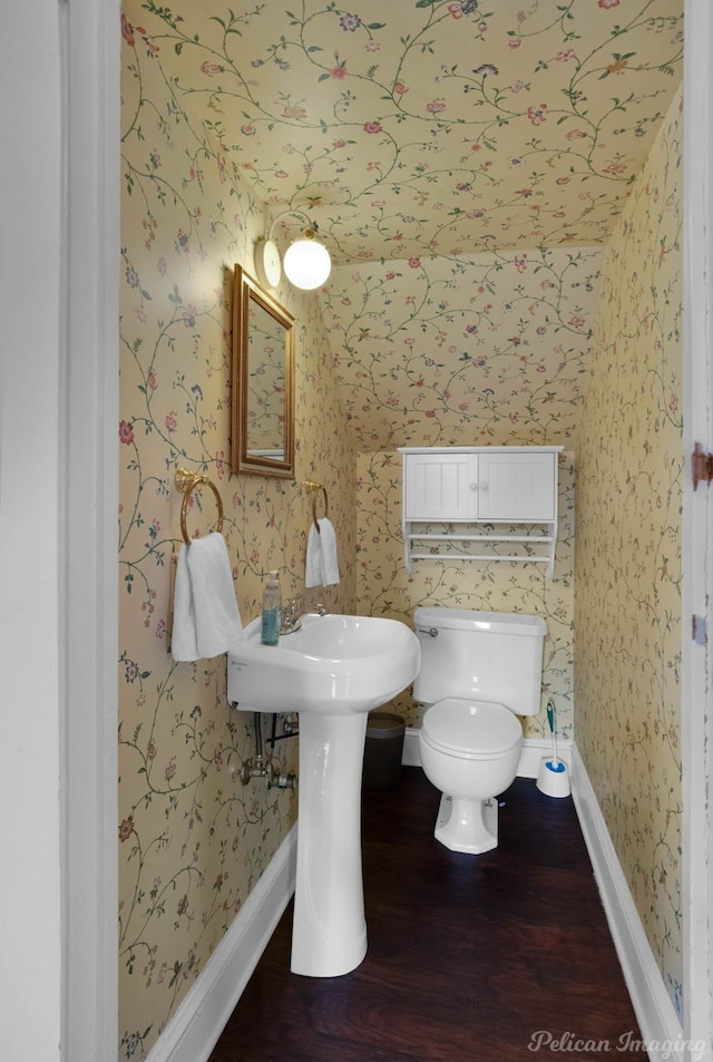 bathroom featuring hardwood / wood-style floors and toilet