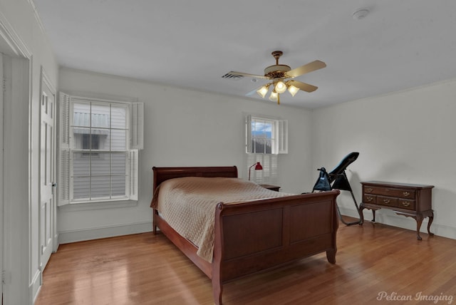 bedroom with light hardwood / wood-style floors and ceiling fan