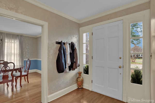 foyer entrance with ornamental molding and light wood-type flooring